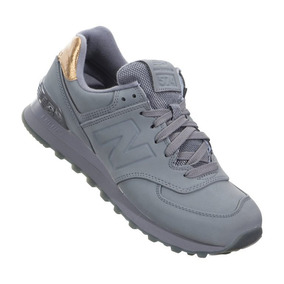 new balance gris y dorado
